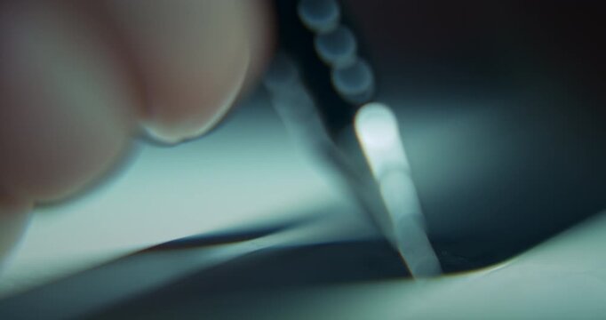 Extreme close-up of man's hand drawing a technical blueprint with a pencil and ruler, captured with shallow depth of field. Detailed drafting and design concept representing architecture, engineering.