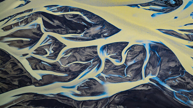 Aerial view of the braided river Tungnaa with intricate glacial sediment patterns and dark volcanic sand channels in Skaftarhreppur, Iceland.