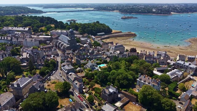 Sainte-Croix Church, Solidor beach, and Barrage de la Rance in Saint-Malo, France. Aerial forward