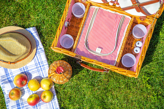 View from above on Picnic basket on green sunny lawn in the park