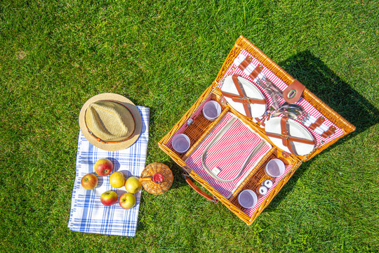 Picnic basket on green sunny lawn in the park