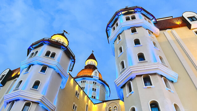 Bogatyr Hotel illuminated at dusk in Sochi