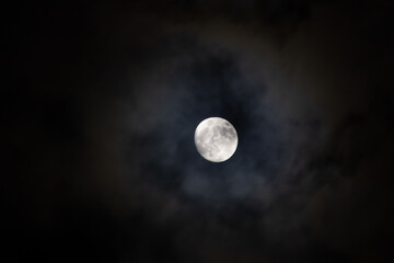 full moon in the clouds at night © ric
