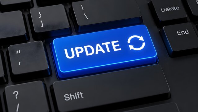 Close up of a glowing blue update button on a black computer keyboard representing software upgrades and system improvements