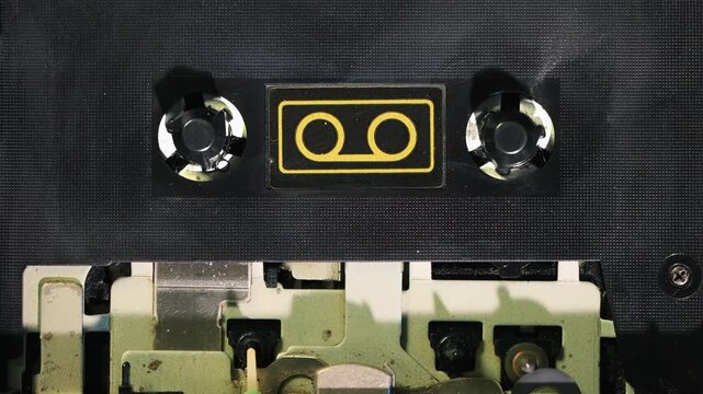 Close-up of cassette deck mechanism stopped automatically using tweezers on mechanical sensor without tape.