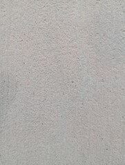 Fototapeta premium Grey concrete wall texture background. Close up of raw cement plaster with fine grain details. Neutral stone surface pattern for architectural visualization and design backdrops.