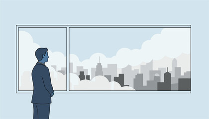 Fototapeta premium Business professional stands by a large office window observing a gloomy city skyline covered in thick grey clouds.