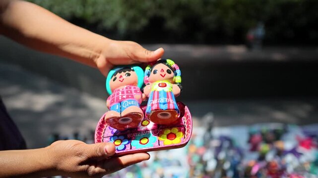Hand Holding Colorful Queretaro Folk Art Dolls Outdoor Souvenir Market