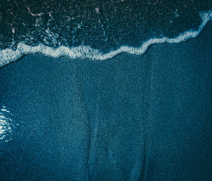 Dark blue wet sand beach 