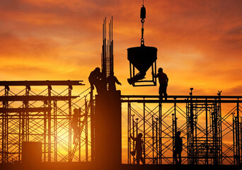 Silhouette of construction crane and unfinished building at sunset © Alif
