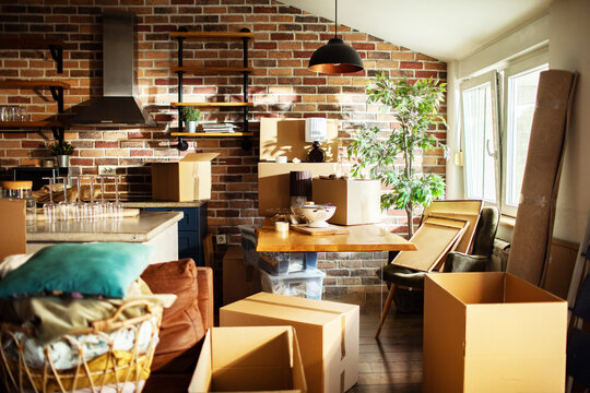 Modern loft kitchen interior with moving boxes