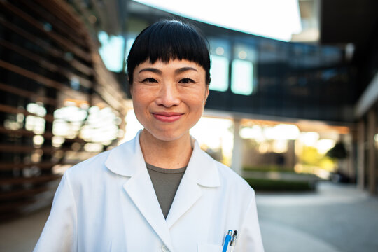 Smiling female doctor outdoors at modern medical campus