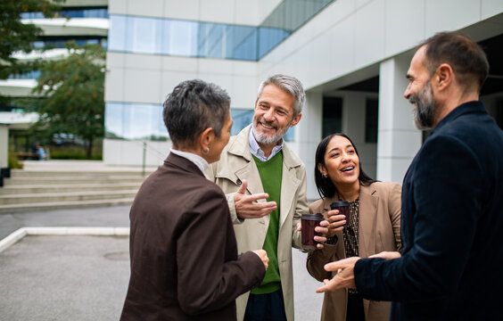 Business colleagues networking over coffee outside the office