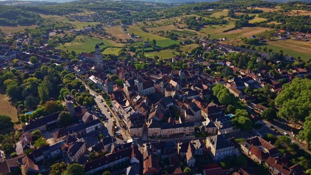 Drone flies forward above Martel village and rural Lot countryside in France