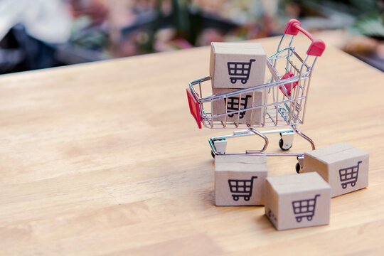 Shopping cart cardboard box ecommerce online store delivery retail purchase commerce market miniature toy small wooden table package shipping