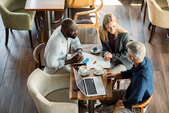 Colleagues discussing business strategy at cafe table