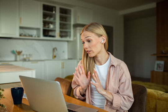 Young woman on video call in a home kitchen