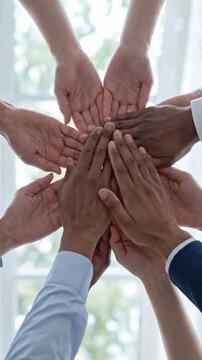 Diverse hands joining circle for teamwork, unity and collaboration, palm gesture expressing inclusion, shared responsibility, people support