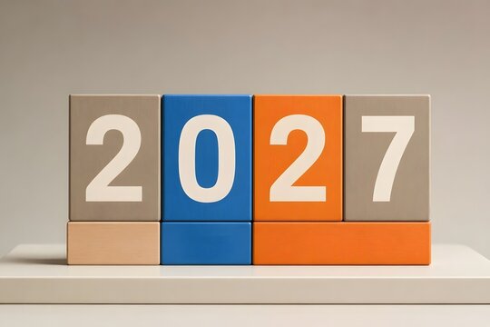 Clean minimalist concrete toy blocks displaying 2027 numbers on studio table in 3D rendering style