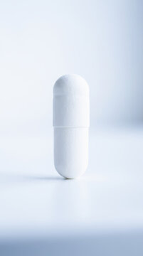 White capsule pill for healthcare insurance concept with clean pharmaceutical styling and soft studio lighting