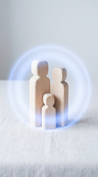 Wooden family figurine with healthcare insurance protection symbolizing security and support for parents and child in home setting