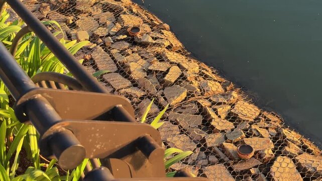 Panoramic motion shot of Gabion Riprap Riverbank at Sunset