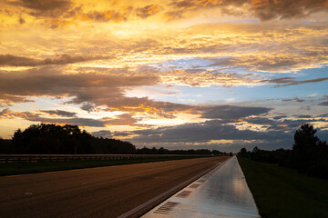Naklejka premium Dramatic sky. Dark clouds illuminated by sunset. Beautiful sky with clouds at dusk. Stormy sky. Scenic view of layered sky textures.