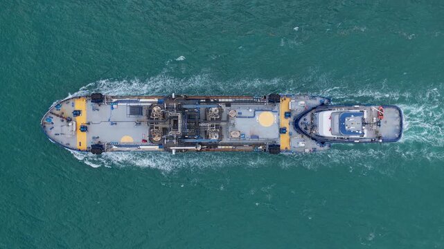 Bunkering tanker aerial top view. Industrial vessel cruising through the sea. Aerial view bunkering vessel. Industrial petrochemical tanker. Fuel tanker vessel