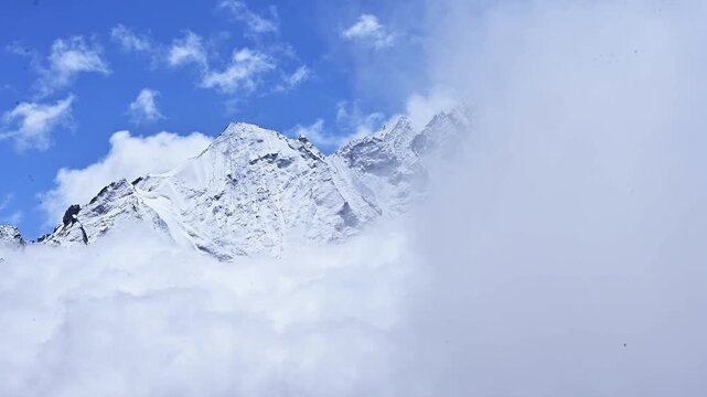 Scenery view of snowcapped mountains seen from Tsergo Ri (4,990m) the high point on the Langtang valley trek of Nepal while covered by fog and clouds.