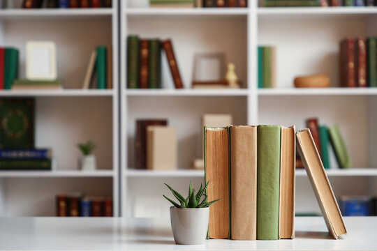 Books with plant on table in home library