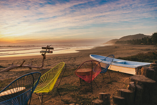 Colorful Beach Chairs and Boat at Sunset. Troncones, Guerrero. Mexico