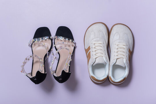 Different styles of shoes comfortable and sophisticated footwear are placed on a colored surface