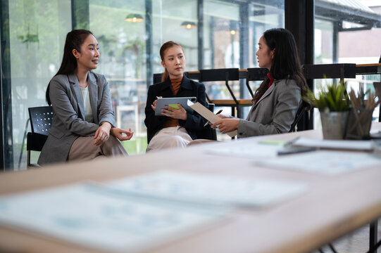 Business meeting with women collaborating and discussing business strategy