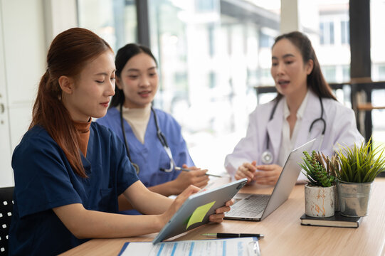 Healthcare professionals collaborating on patient care and medical information with digital devices