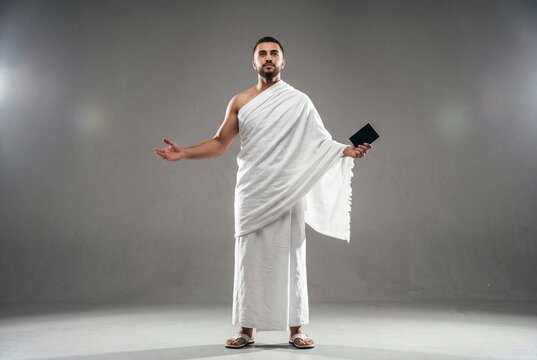 Young Saudi Man Wearing Ihram Clothing for Hajj Pilgrimage in Studio Portrait