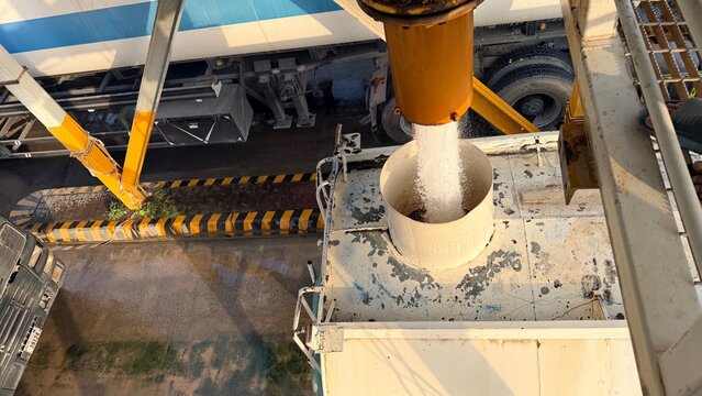 An industrial tanker fills from a high‑pressure overhead pipe at a refilling bay near EGA in Dubai&rsquo;s logistics zone.