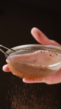 Sifting cocoa powder through a fine mesh strainer