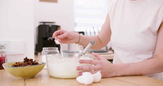 Home cooking. Kneading dough. Female chef hand adding measuring ingredient salt sugar in glass bowl with flour mixing whisk pastry mass.