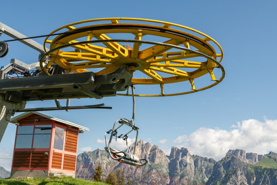 Dolomites, Italy. Chairlift and cableway infrastructure with dramatic Alpine mountain landscape