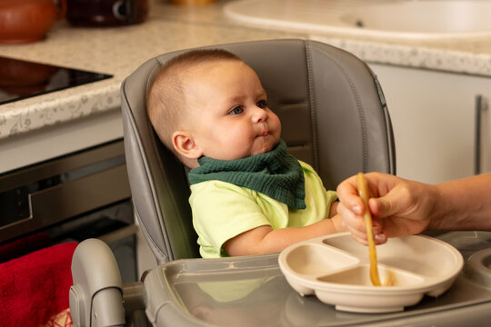 Hesitant Baby Boy Waits During Kitchen Feeding Time