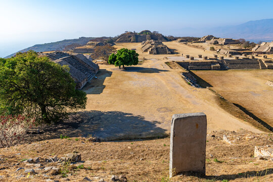 Monte Alban cityscape with stela and pyramids, Oaxaca, Mexico.