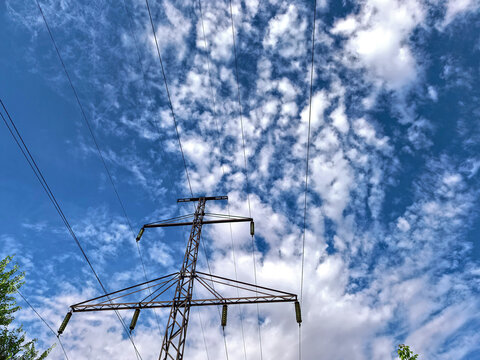 High Voltage Power Tower Beneath Dramatic Cloudy Sky