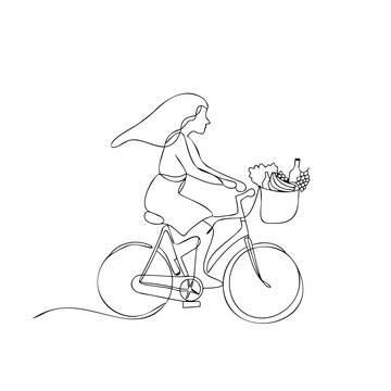 Woman riding bicycle with basket full of fresh organic groceries on sunny day for eco friendly transport or lifestyle advertising.