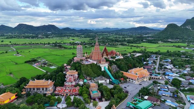 Drone Orbit Tiger Cave Temple Rising Above Rice Fields in Kanchanaburi, Thailand