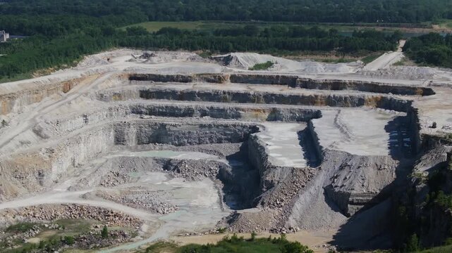 Terraced Levels of an Open Pit Limestone Quarry - Forward Drone Shot