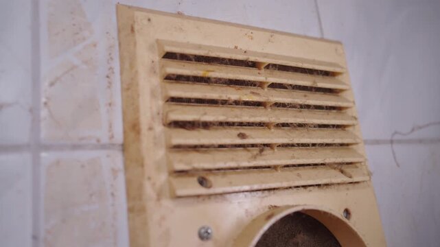 Dirty Kitchen Ventilation Grille Covered in Grease and Dust | Clogged Air Vent Cover Needing Cleaning and Maintenance | HVAC Service and Home Repair Concept