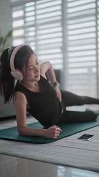 Young asian woman exercises workout at home