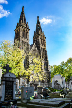 Gothic spires of Vysehrad Basilica rising above a historic Prague cemetery
