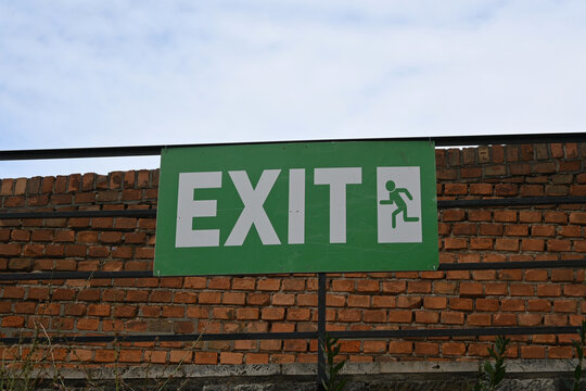 Emergency exit sign on brick wall