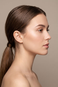 Young woman with pulled back hair in profile portrait